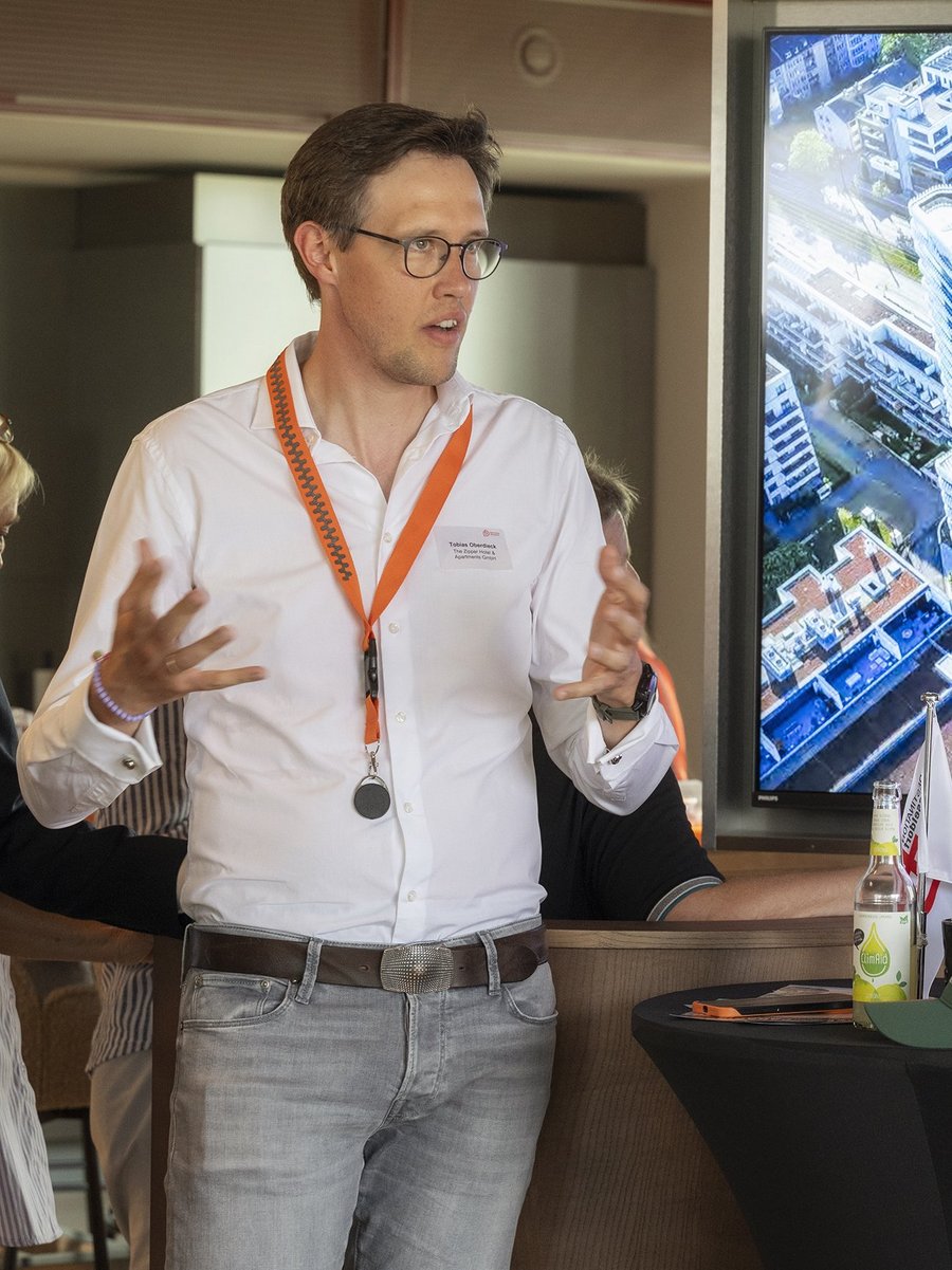 Ein Mann präsentiert ein Bauprojekt auf einem großen Bildschirm