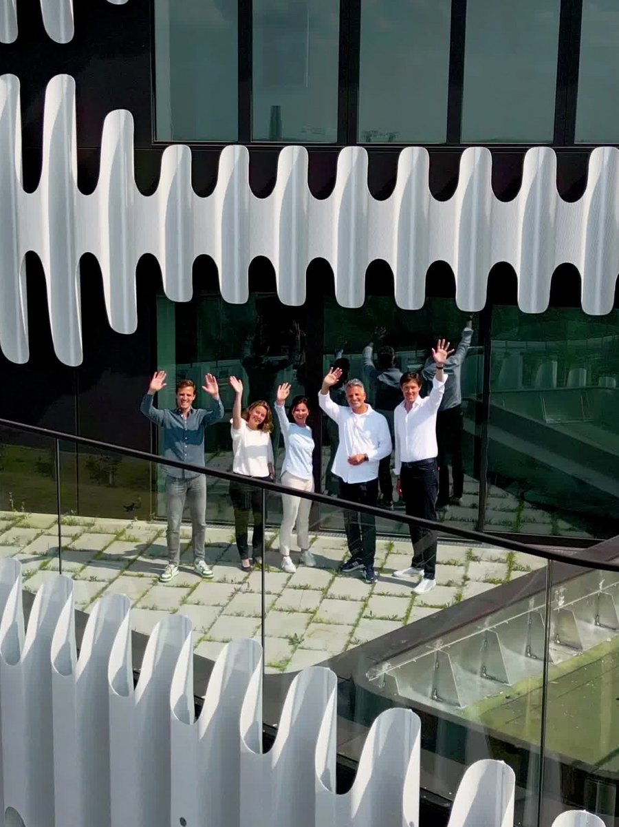 The Zipper team waving on the terrace